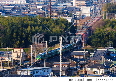 A JR Nara Line train crossing the Kizugawa River bridge. View from Shiroyamadai Castle Ruins Park, Kizugawa City, Kyoto Prefecture. A JR Nara Line train crossing the Kizugawa River bridge. View from Shiroyamadai Castle Ruins Park, Kizugawa City, Kyoto Prefecture. 135664872