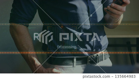 Holding smartphone, business casual male viewing processing overlay at desk, with progress bars 135664983