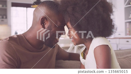 Pressing foreheads father and daughter bonding in home living room, with sofa throw pillows Pressing foreheads father and daughter bonding in home living room, with sofa throw pillows 135665015