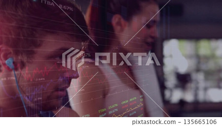 Monitoring stock charts, analyst duo working on trading floor with wireless earbud, copy space 135665106