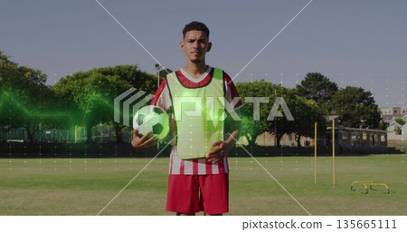 Soccer player holding ball in sports field, with fluorescent vest slalom poles hurdles and waveform Soccer player holding ball in sports field, with fluorescent vest slalom poles hurdles and waveform 135665111