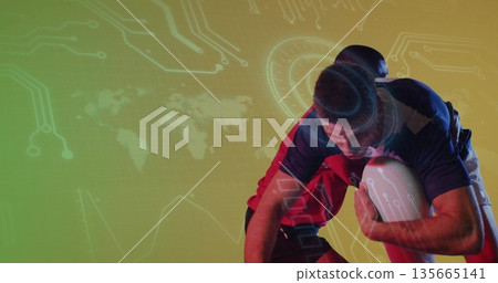 Tackling opponent wearing jersey and carrying white rugby ball in studio, with digital overlay 135665141