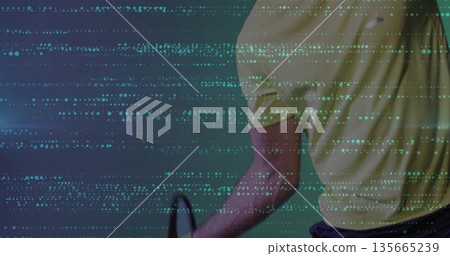 Gripping tennis racket athlete wearing yellow polo shorts in digital code environment, copy space 135665239