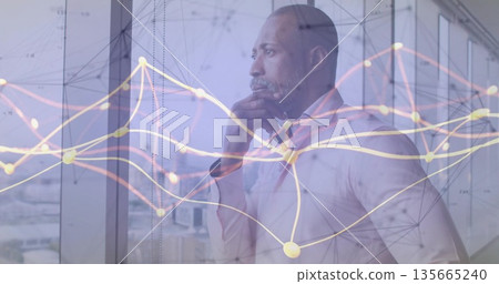Gazing mature businessman resting hand on chin at office glass window, digital network overlay 135665240