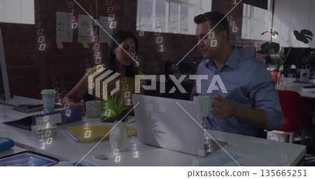 Collaborating on project documents coworkers holding coffee mugs at modern office desk, with laptop Collaborating on project documents coworkers holding coffee mugs at modern office desk, with laptop 135665251