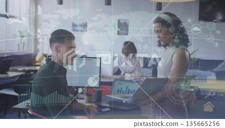 Presenting woman holding laptop in office while colleagues analyzing charts, copy space 135665256