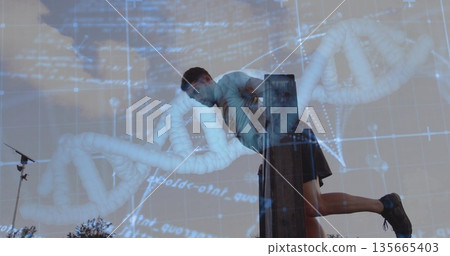 Leaning on wooden beam, man doing dip exercise outdoors, with tripod stand and DNA graphic overlay Leaning on wooden beam, man doing dip exercise outdoors, with tripod stand and DNA graphic overlay 135665403