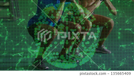 Squatting partners wearing lace-up running shoes at fitness studio, with green data overlay 135665409