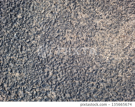 This is a close-up of an asphalt road. 135665674