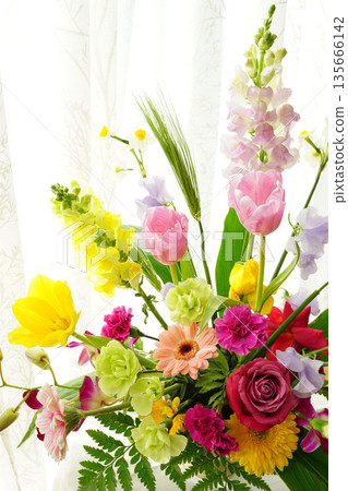 Gorgeous flower arrangement on the windowsill Gorgeous flower arrangement on the windowsill 135666142