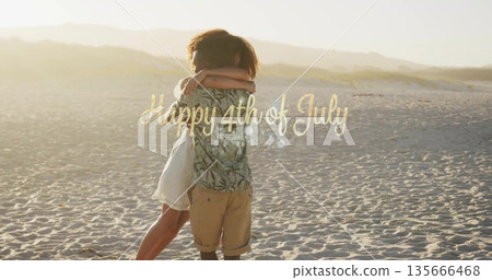 Embracing couple wearing tropical shirt and dress on sunset beach with Happy 4th of July overlay 135666468