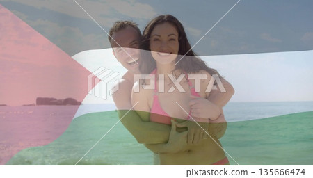 Hugging man wrapping arms around woman at turquoise water edge, with pink bikini, blue swim trunks Hugging man wrapping arms around woman at turquoise water edge, with pink bikini, blue swim trunks 135666474