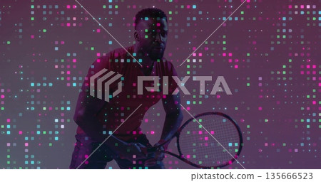 Gripping tennis racket male athlete in red shirt adopting ready stance in studio with pixel squares 135666523