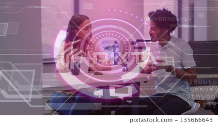 Gesturing woman and leaning man discussing digital globe in office, with smartphone mug pen overlay 135666643