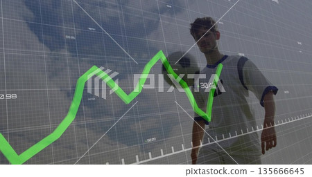 Controlling athlete in jersey balancing soccer ball on soccer field, with grid and green line graph 135666645