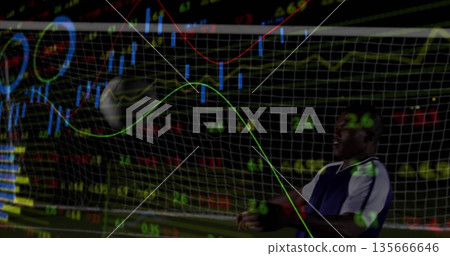 Standing male athlete tracking incoming ball in goal at night, with financial charts, copy space 135666646