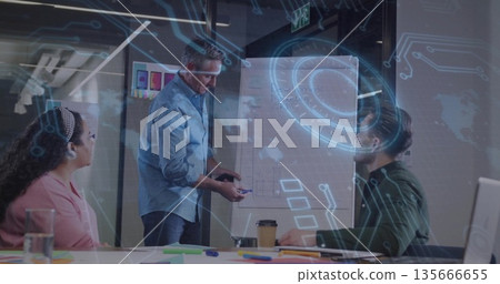 Presenting mature male wearing suit explaining strategy in business conference room, with flipchart 135666655