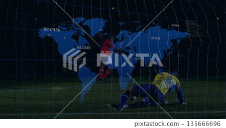 Red-jersey forward shooting soccer ball towards goal on pitch at night, with world map grid overlay Red-jersey forward shooting soccer ball towards goal on pitch at night, with world map grid overlay 135666696