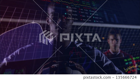 Holding soccer ball player wearing jersey standing by goal net, with financial chart overlays 135666724