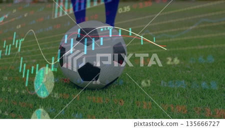 Lying soccer ball on grass pitch near player in blue socks, black cleats showing candlestick chart Lying soccer ball on grass pitch near player in blue socks, black cleats showing candlestick chart 135666727