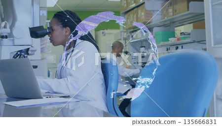 Examining woman scientist in lab coat operating microscope, using laptop at lab bench, copy space Examining woman scientist in lab coat operating microscope, using laptop at lab bench, copy space 135666831