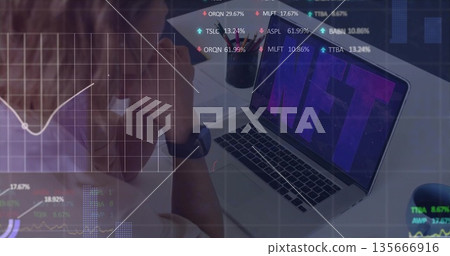 Leaning mid-adult woman analyzing NFT data at office workspace, with laptop and charts, copy space 135666916