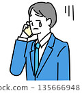 Illustration of a young businessman crying while on the phone 135666948