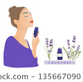 A woman enjoying the scent of lavender with lavender flowers and essential oils 135667090