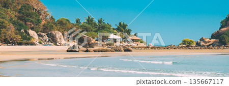 Canacona, Goa, India. Sunny Sky Over Calm Water Of Arabian Sea. Natural Landscape With Sandy Palolem Beach At Sunny Summer Day With Blue Sky Canacona, Goa, India. Sunny Sky Over Calm Water Of Arabian Sea. Natural Landscape With Sandy Palolem Beach At Sunny Summer Day With Blue Sky 135667117