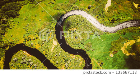 Aerial View Green Forest Woods And River Landscape In Sunny Spring Summer Day. Top View Of Beautiful European Nature From High Attitude In Autumn Season. Drone View. Bird's Eye View Aerial View Green Forest Woods And River Landscape In Sunny Spring Summer Day. Top View Of Beautiful European Nature From High Attitude In Autumn Season. Drone View. Bird's Eye View 135667118
