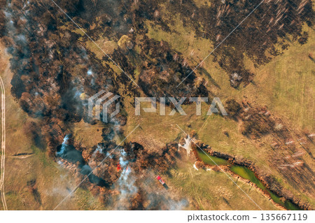 Wild Open Fire Destroys Grass. Nature In Danger. Natural Disaster. Concept Of Save Nature. Aerial View Of Dry Grass Burns During Drought And Hot Weather. Bush Fire And Smoke In Meadow Field Wild Open Fire Destroys Grass. Nature In Danger. Natural Disaster. Concept Of Save Nature. Aerial View Of Dry Grass Burns During Drought And Hot Weather. Bush Fire And Smoke In Meadow Field 135667119