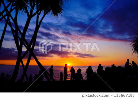 沖繩人看美麗的日落浪漫海岸 135667195