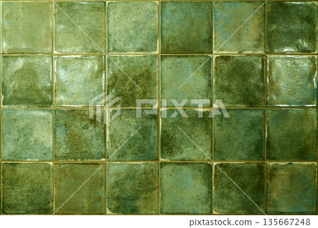 Green ceramic tile background. Old vintage ceramic tiles in green to decorate the kitchen or bathroom 135667248