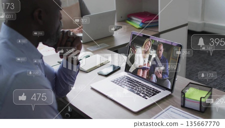 Leaning African American man focusing on laptop at office desk with notification icons, copy space Leaning African American man focusing on laptop at office desk with notification icons, copy space 135667770