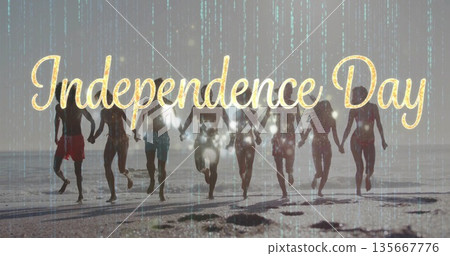Running eight friends in swimwear holding hands at beach, gold Independence Day text green overlay 135667776
