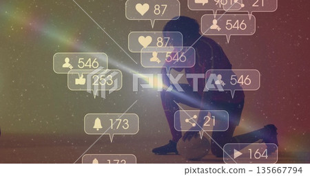 Shining smartphone beam kneeling athlete in sportswear lighting digital sky with icons, soccer ball 135667794