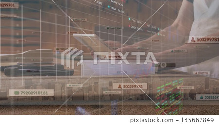 Asian man wearing white shirt analyzing virtual financial charts on laptop at desk, copy space 135667849