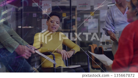 Reviewing woman in yellow turtleneck leading meeting in modern conference room, with sticky notes Reviewing woman in yellow turtleneck leading meeting in modern conference room, with sticky notes 135667872
