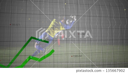 Diving goalkeeper in yellow kit catching soccer ball at goalmouth at night, with green trend lines 135667902