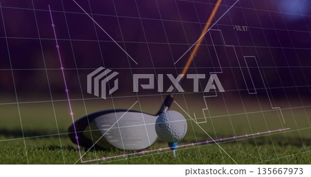 Positioning white golf ball on blue tee under poised driver head on fairway, showing data overlay 135667973