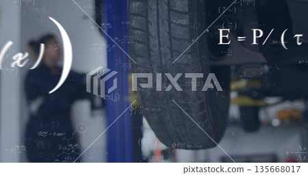 Showing car tire wheel assembly revealing undercarriage in workshop with hydraulic lift and tools 135668017