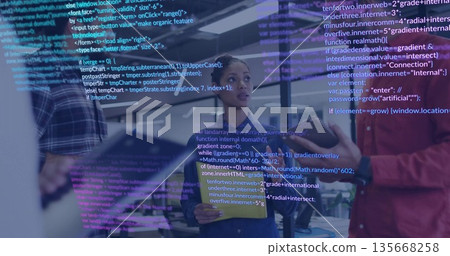 Holding tablet denim-jacketed engineer listening in open office, with code overlay and monitors Holding tablet denim-jacketed engineer listening in open office, with code overlay and monitors 135668258