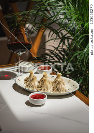 Georgian khinkali dumplings served with wine Georgian khinkali dumplings served with wine 135668279
