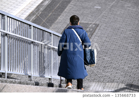 Yokohama cityscape stairs in Japan...Aging society. An elderly woman with a cane (in a pose). It seems like it's a struggle to go down the stairs. They're steep and scary... 135668733