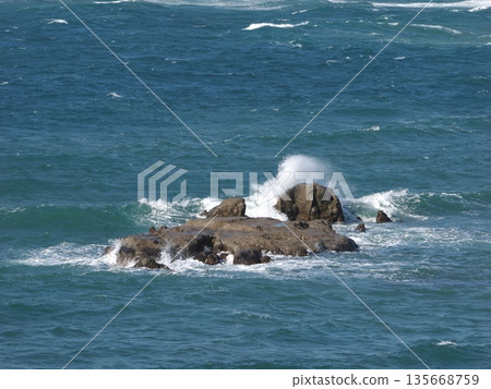 Wave splash against the rock Wave splash against the rock 135668759