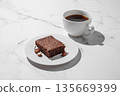 Pieces of chocolate brownie on a plate and a cup of espresso coffee on a marble background 135669399