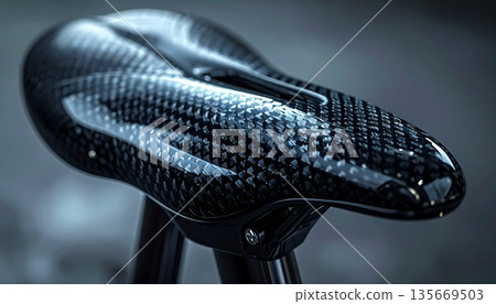 A close-up image of a bicycle seat with a worn, coated cover. A close-up image of a bicycle seat with a worn, coated cover. 135669503