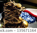 Chinese dragon statuette and blue beads 135671164
