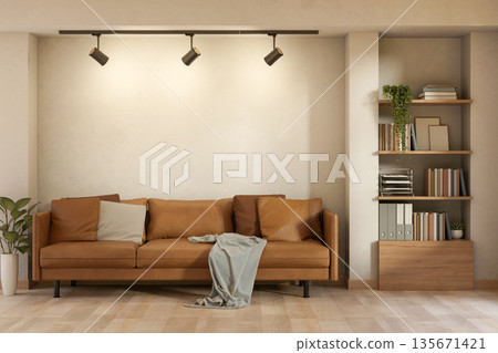 Brown leather sofa with cushion and blanket aside bookshelf on wooden parquet floor of living room. Brown leather sofa with cushion and blanket aside bookshelf on wooden parquet floor of living room. 135671421