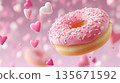 Pink frosted donut with heart sprinkles against soft pink background 135671592